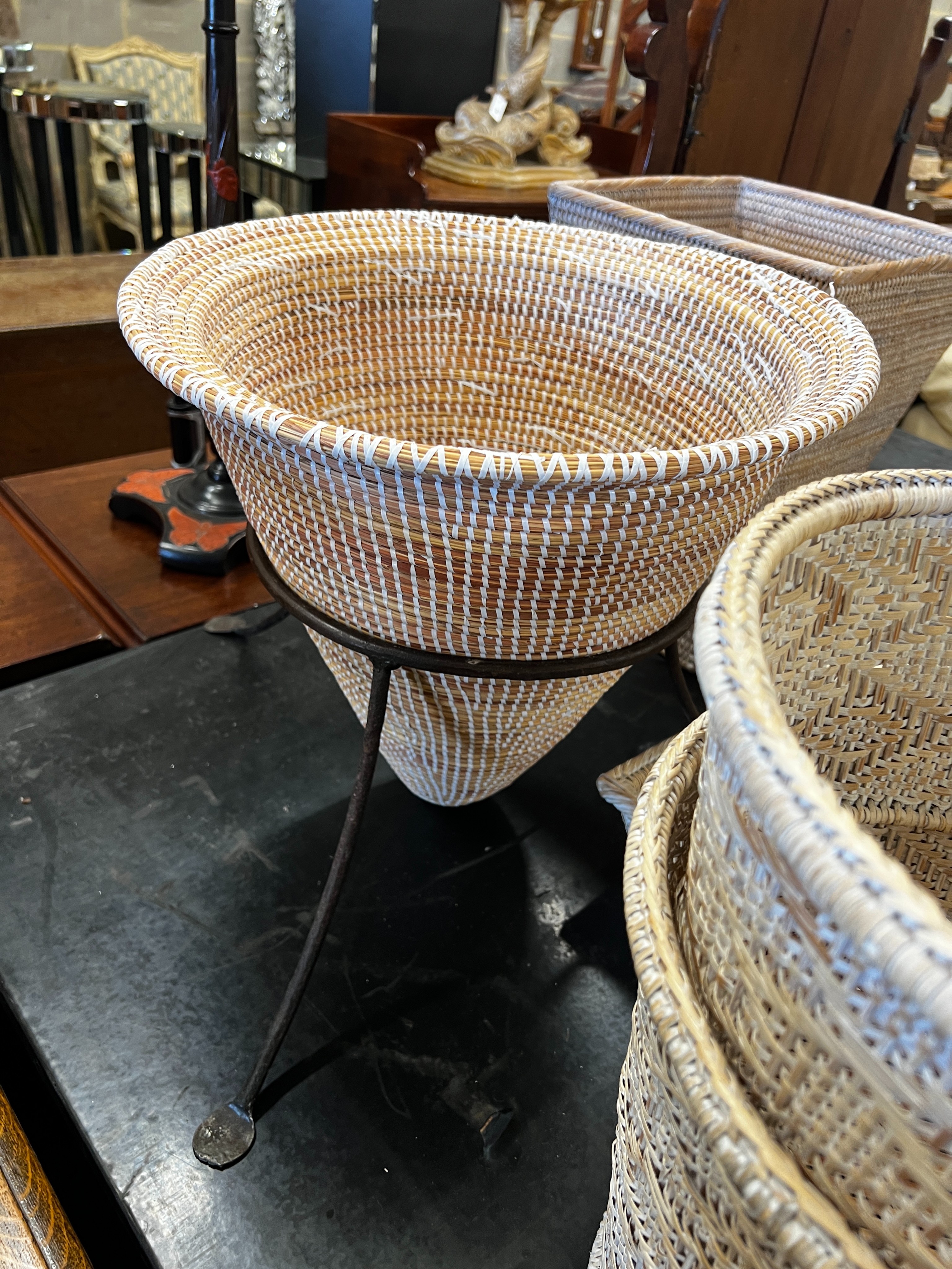 A wicker tray on folding stand together with nine other pieces of wickerwork